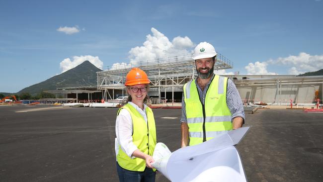 Woolworths regional development manager Marissa Hopewell and state development manager Chris Sheehan look over plans for the new supermarket in front of the construction. Picture: Brendan Radke