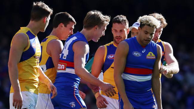 Eagles players rough up Jason Johannisen. Pic: Michael Klein