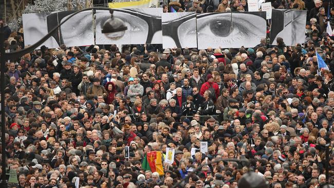 PARIS, FRANCE - JANUARY 11: Demonstrators gather in Place de la Republique prior to a mass unity rally to be held in Paris following the recent terrorist attacks on January 11, 2015 in Paris, France. An estimated one million people are expected to converge in central Paris for the Unity March joining in solidarity with the 17 victims of this week's terrorist attacks in the country. French President Francois Hollande will lead the march and will be joined by world leaders in a sign of unity. The terrorist atrocities started on Wednesday with the attack on the French satirical magazine Charlie Hebdo, killing 12, and ended on Friday with sieges at a printing company in Dammartin en Goele and a Kosher supermarket in Paris with four hostages and three suspects being killed. A fourth suspect, Hayat Boumeddiene, 26, escaped and is wanted in connection with the murder of a policewoman. (Photo by Christopher Furlong/Getty Images)