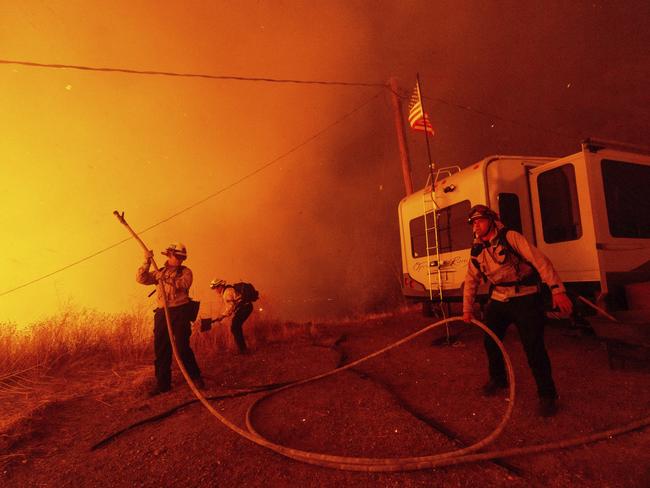 Firefighters spray water on the Hughes Fire in Castaic, California. Picture: AP