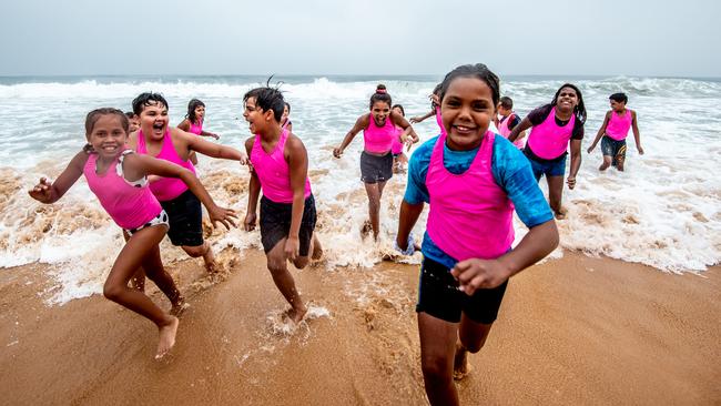 Kids from far west NSW experience the ocean and the rain on the northern beaches. Picture: Julie Cross.