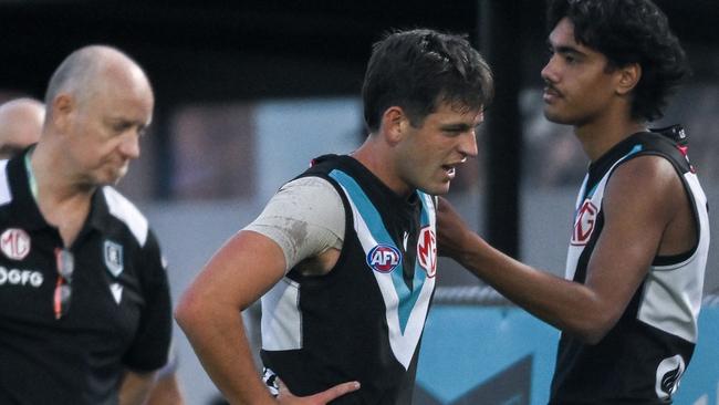 ADELAIDE, AUSTRALIA - MARCH 01:  Zak Butters of the Power   leave the ground after hurting his ankle during the 2024 AFL Community Series match between Port Adelaide Power and Fremantle Dockers at Alberton Oval on March 01, 2024 in Adelaide, Australia. (Photo by Mark Brake/Getty Images)