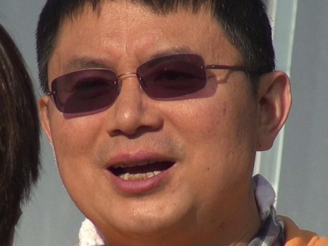 In this Dec. 2013, photo, Xiao Jianhua, a Chinese-born Canadian billionaire talks to reporter outside the International Finance Centre in Hong Kong. Mystery surrounds the whereabouts of Xiao reportedly taken away from his Hong Kong hotel by mainland police in a case that could rekindle concerns about overreach by Chinese law enforcement in the semiautonomous city. (AP Photo/Next Magazine)