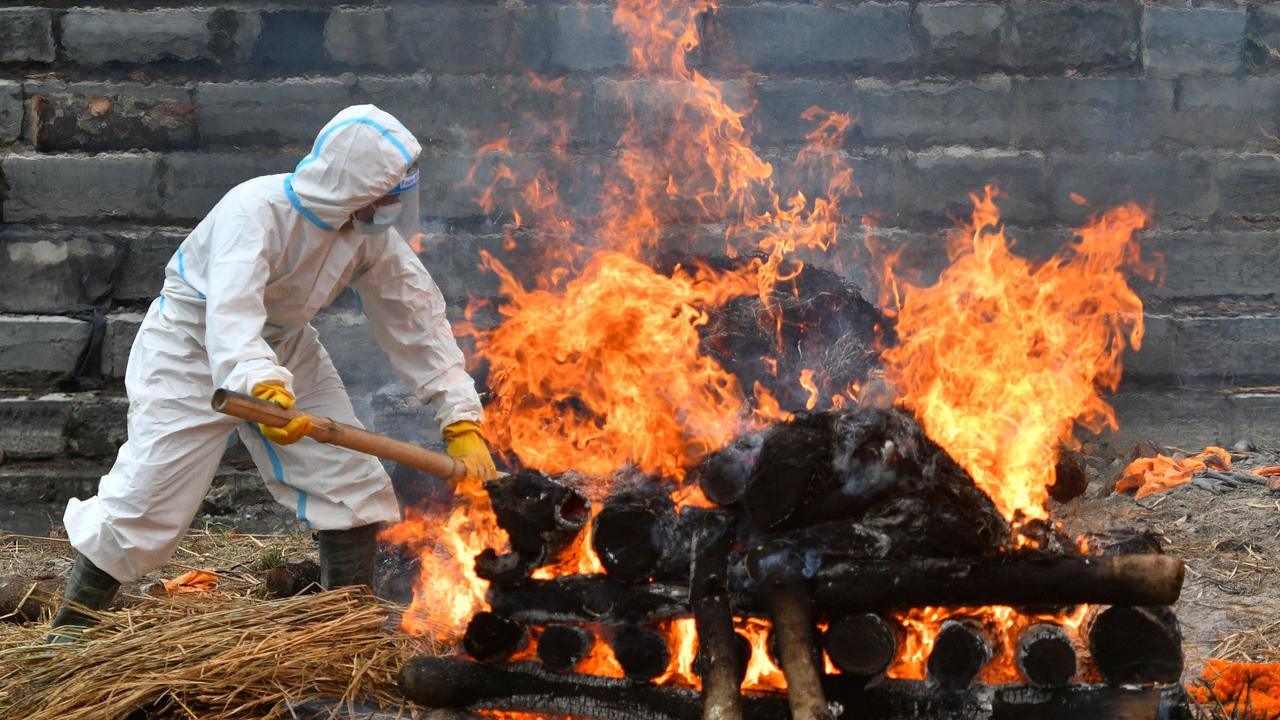 A funeral pyre of person who died from COVID-19 in Kathmandu (Photo by PRAKASH MATHEMA / AFP)