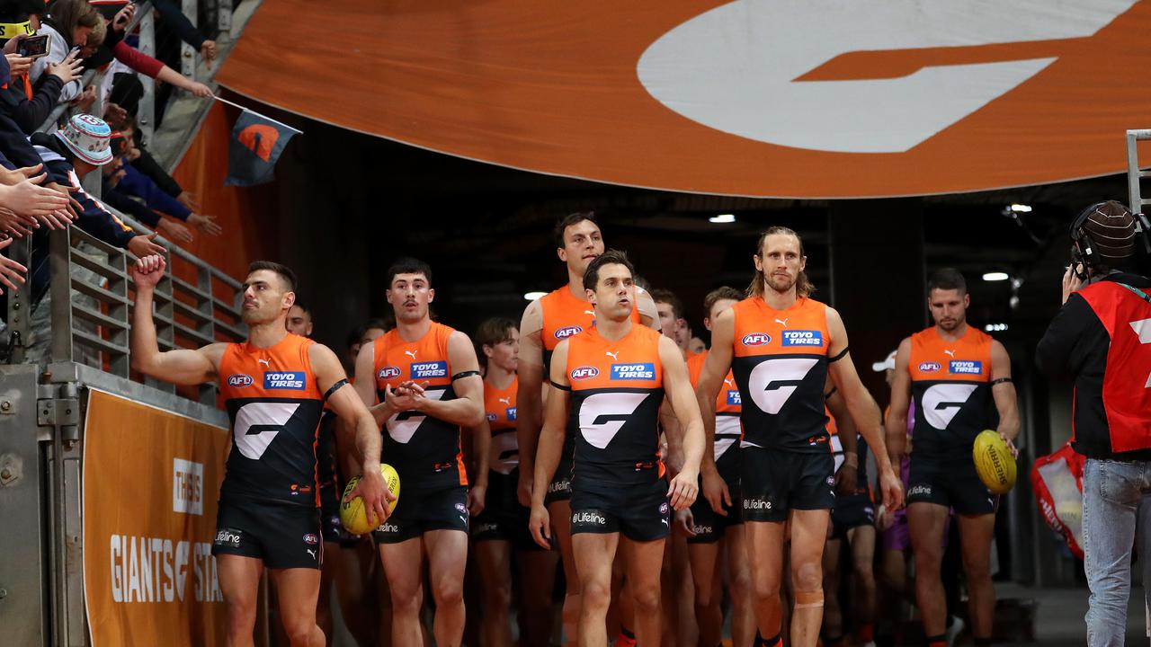 Stephen Coniglio and Josh Kelly lead the Giants out.