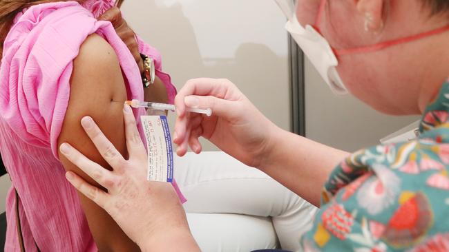 MELBOURNE, AUSTRALIA - NewsWire Photos, DECEMBER 23, 2021. A woman ( I was asked not to use names) receives her booster covid shot at the Sandown Racecourse COVID Vaccination centre . Picture: NCA NewsWire / David Crosling