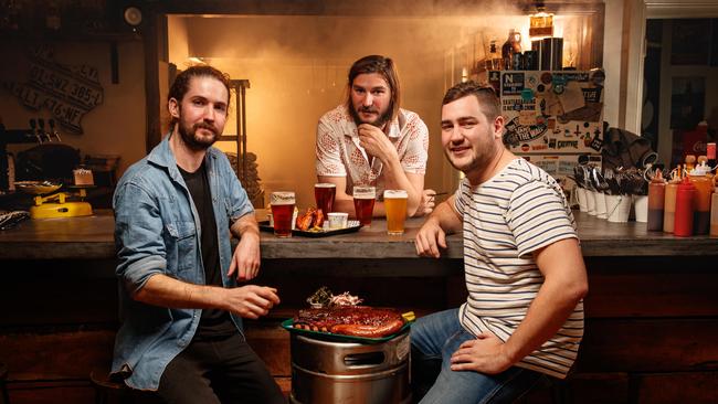 Founders of Low and Slow American BBQ, Angus Kiley, Jim Morrison and Angus Henderson in their Port Adelaide restaurant. Photo: Matt Turner