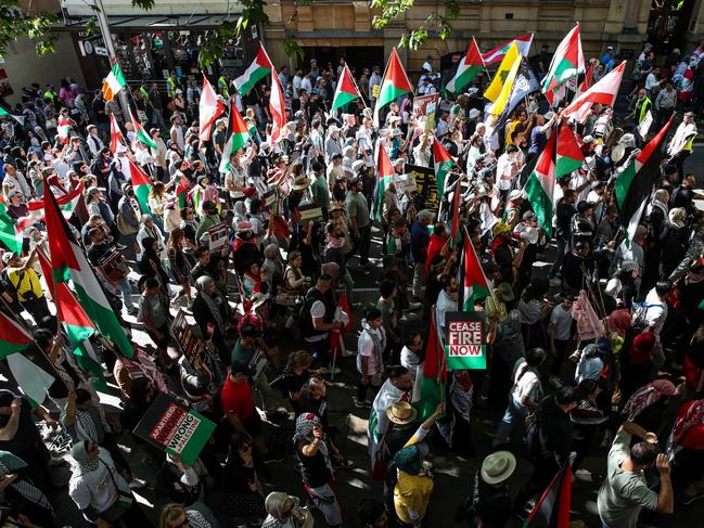 SYDNEY, AUSTRALIA - OCTOBER 06: Protesters march through the CBD on October 06, 2024 in Sydney, Australia. Organizers of pro-Palestine protests in Sydney are set to proceed with a rally on Sunday, October 6, despite legal attempts by police to prohibit the gatherings due to safety concerns related to anticipated crowd sizes and potential disruptions. The following day, a vigil is scheduled to honor victims of violence in Gaza, coinciding with the one-year anniversary of the Hamas attacks, which has drawn criticism from government officials who deem the timing "extremely provocative". Protesters also planned to gather for similar events in Melbourne. (Photo by Roni Bintang/Getty Images)