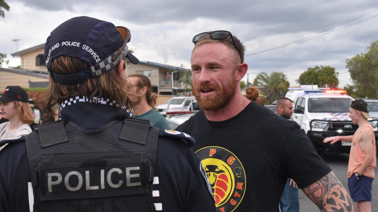 Torin O'Brien speaking with Rockhampton police during the community rally he led last year.