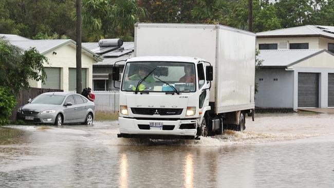 A truck drives through flood water on Campbell Street in Gordonvale after heavy rain caused flooding to the area south of Cairns. Picture: Brendan Radke