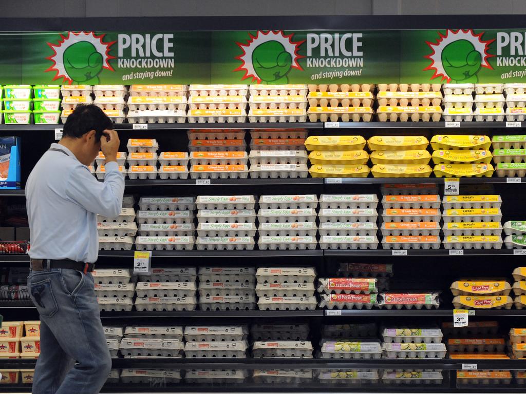 A shopper inspects eggs inside a Woolworths in 2011. Picture: Dave Hunt/AAP