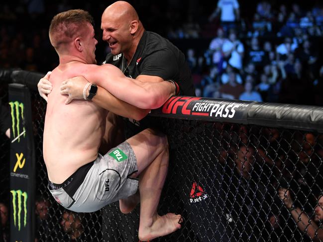 Crute celebrates his debut UFC win with coach Sam Greco in 2018. Picture: Jeff Bottari/Zuffa LLC/Zuffa LLC via Getty Images