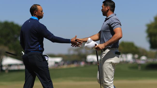 Tiger Woods shot five strokes better than playing partner Jason Day.