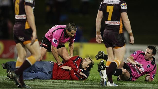 Jared Maxwell is tacked by a Wests Tigers fan. 