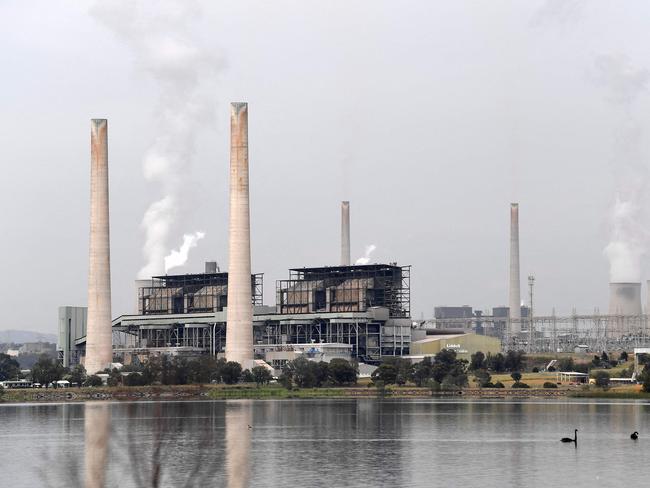 (FILES) This file picture taken on November 4, 2021 shows steam rising from the cooling towers of the Liddell Power Station next to Lake Liddell in the town of Singleton, some 70km (43 miles) from Newcastle, the world's largest coal exporting port. - Australia's oldest coal-fired power plant will shut down on April 28, 2023, as the country, a once-notorious climate straggler, prepares for a seismic shift towards renewable energy. (Photo by Saeed KHAN / AFP) / TO GO WITH: Australia-climate-politics-energy-coal, by Steven TRASK