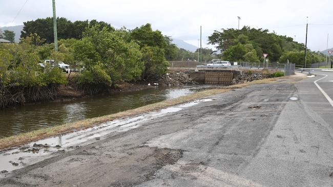 A bus driver has been rescued by police from his submerged vehicle which had crashed into Smiths Creek near Fearnley Street at Bungalow on Sunday night. PICTURE: BRENDAN RADKE.