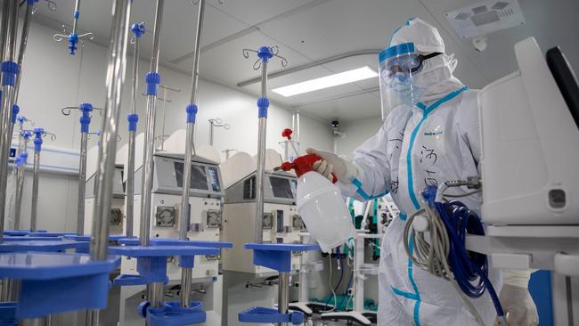 A staff member sprays disinfectant on medical equipment after all patients left Leishenshan Hospital – built in Wuhan in two weeks – after it closed on April 14. Picture: AP