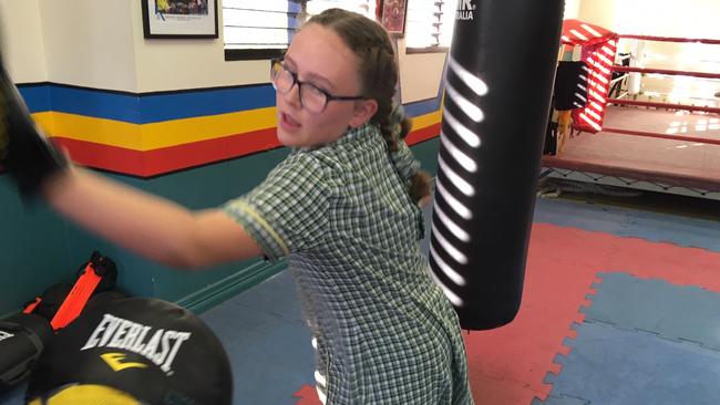 Jeff Horn watches Lauren McKenzie do some pad work.