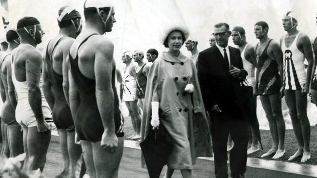 Queen Elizabeth II walks along a Gold Coast street lined with lifesavers during the 1963 tour.