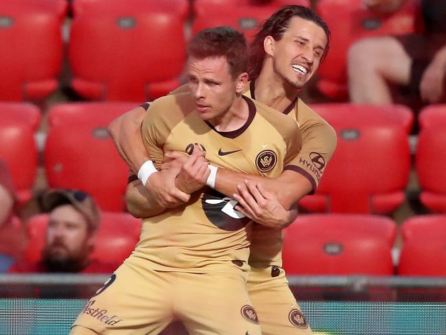 Western Sydney Wanderers fullback Daniel Georgievski hugs teammate Nicolai Muller after Muller scored against Adelaide. Picture: AAP