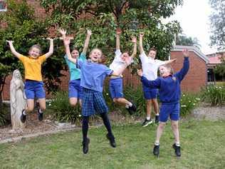 BRAIN POWER: St Carthage's Primary School students L-R Charlotte Gilliland, Neve Schweizer, Padraig Heffernan, Liam Torrens,(front) Darcy Heffernan and Chloe Lane, jump for joy as they are off to defend their champion title the Social Science division of the Tournament of Minds Australian-Pacific Final next month. Picture: Alison Paterson