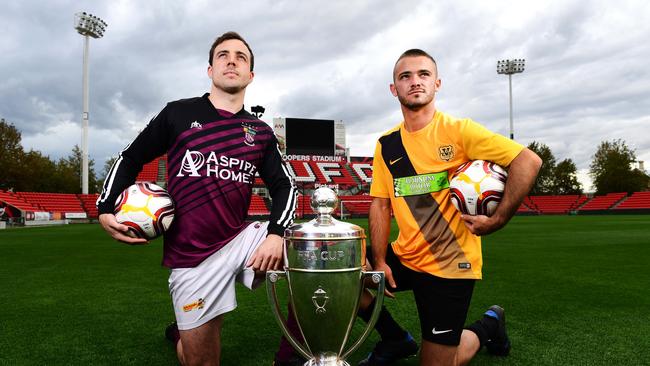 Elizabeth Downs’ Matt Watson and James Greaves of Elizabeth Vale pose with the FFA Cup SA prior to the round-of-16. Picture: Mark Brake