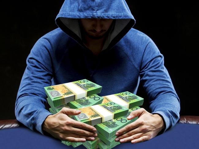 Poker player sitting at a poker table trying to hide his expressions and taking poker chips after winning