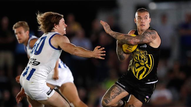 Reigning Brownlow Medallist Dustin Martin fends off Ben Brown of the Kangaroos during the JLT Series. Picture: Adam Trafford/AFL Media/Getty Images