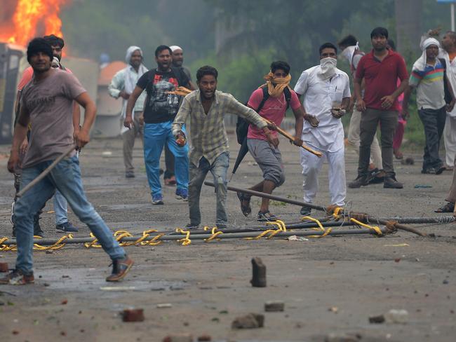 Supporters of Indian religious leader Gurmeet Ram Rahim Singh clash with security forces. Picture: AFP