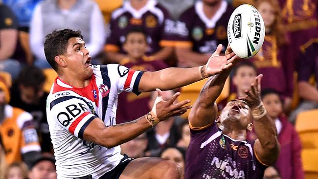 Latrell Mitchell flies high for the Roosters.