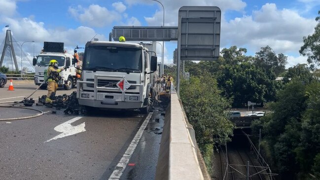 Screengrabs from video. MAJOR TRAFFIC IMPACTS AS TRUCK CATCHES FIRE ON ANZAC BRIDGE, PYRMONT. 11 MarCH 2024 12:32pm Photo: NSW Fire and Rescue