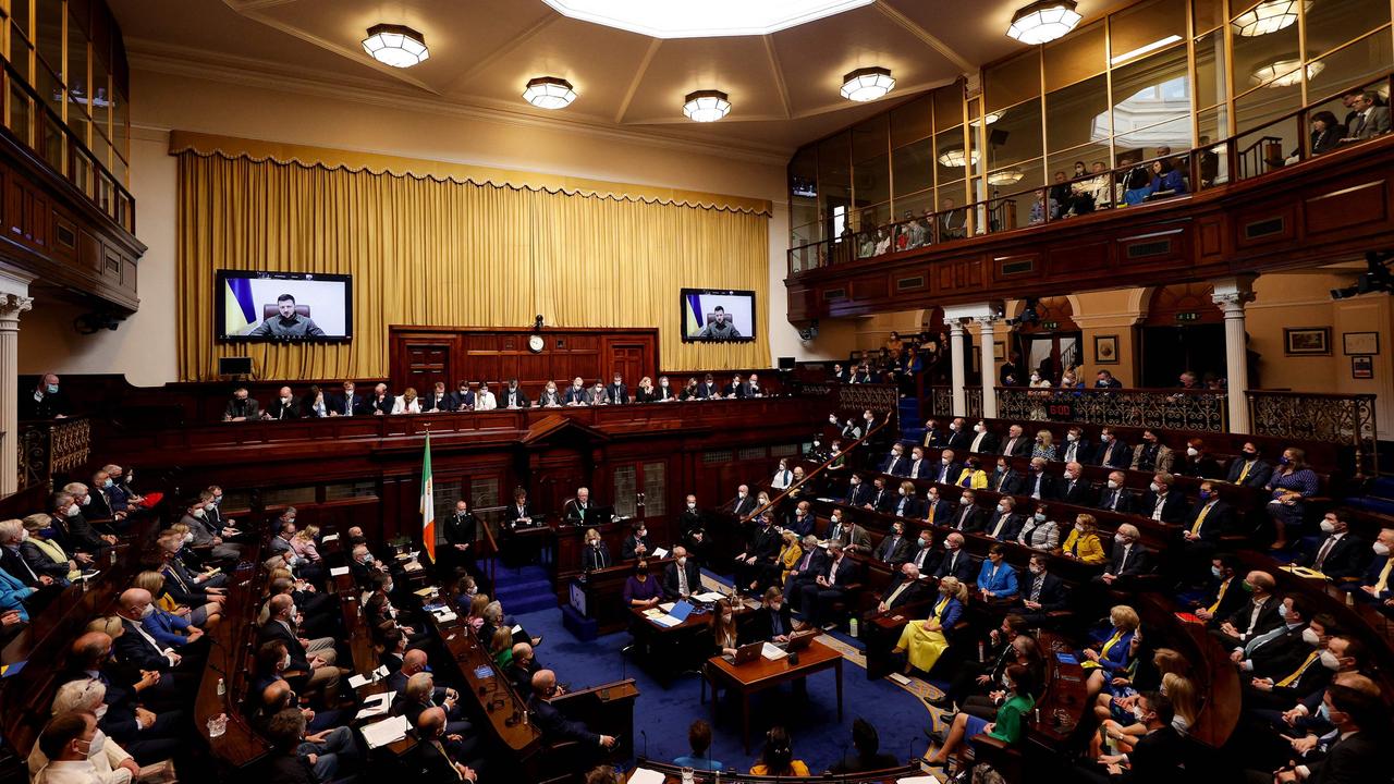 Ukraine's President Volodymyr Zelensky on giant screens as he addresses members of the lower and upper houses of the Irish parliament in Dublin. Picture: MAXWELLS / AFP