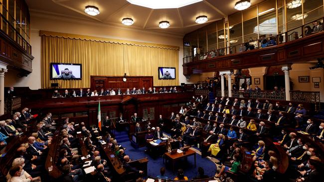 Ukraine's President Volodymyr Zelensky on giant screens as he addresses members of the lower and upper houses of the Irish parliament in Dublin. Picture: MAXWELLS / AFP