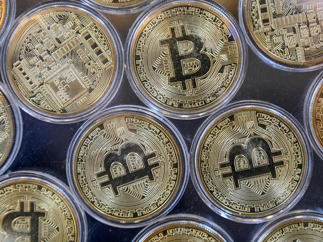 Physical imitation of Bitcoins are pictured at a cryptocurrency exchange branch near the Grand Bazaar in Istanbul on October 20, 2021, a day after Bitcoin took another step closer to mainstream investing with the launch of a new security on Wall Street tied to futures of the cryptocurrency. (Photo by Ozan KOSE / AFP)