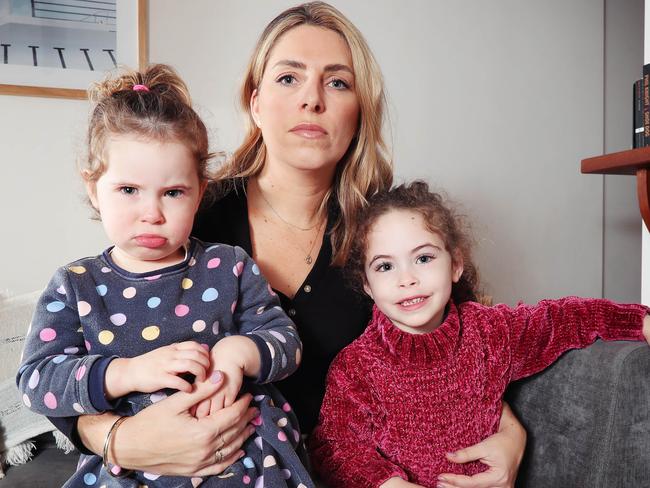 Parents are struggling to keep up with the rising cost of childcare. Some childcare centres charge the same amount in weekly fees as private schools do. Madeleine Hayes, 36, who pays for childcare for her two girls Matilda Balalas, 4, and Harper Balalas, 2 (spotted dress) at their home in South Yarra. Picture Rebecca Michael.