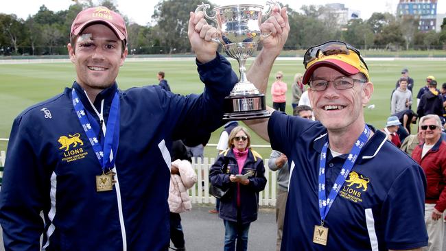 Fitzroy Doncaster’s Peter Dickson (L) and coach Michael O'Sullivan (R) lift the 2015-16 cup. Picture: Hamish Blair