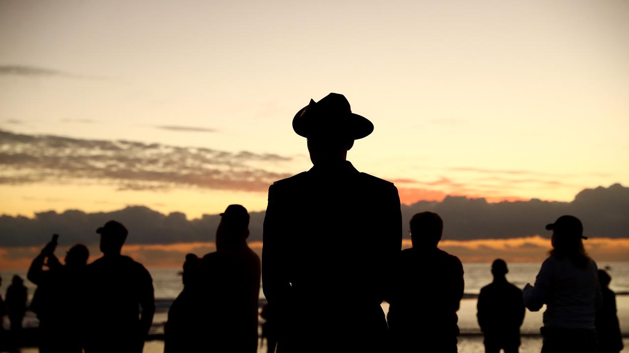 People gather on Currumbin beach to watch surf boats perform a burial at sea on April 25, 2021 in Currumbin. Picture: Chris Hyde/Getty Images