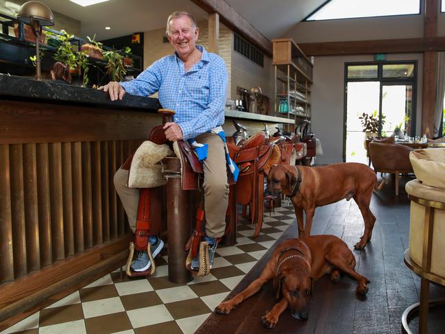 Singo and his dogs inside his restaurant, Saddles. Picture: Justin Lloyd