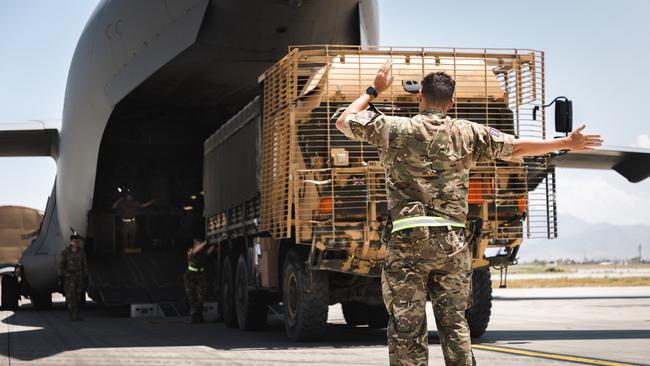 A broken down truck is winched aboard a RAF C-17 Globemaster. Picture: Getty Images