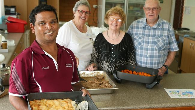 Fr Daniel Jayaraj with volunteers Margaret Coombs, Fay Nolan and Allan Bertling preparing food for the soup kitchen at All Saints Anglican Church Chermside. Picture: AAP/Jono Searle