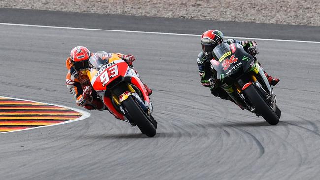 Spanish Honda rider Marc Marquez (L) and German Yamaha rider Jonas Folger compete during the MotoGP competition of the Moto Grand Prix of Germany at the Sachsenring Circuit on July 2, 2017 in Hohenstein-Ernstthal, eastern Germany.  / AFP PHOTO / ROBERT MICHAEL