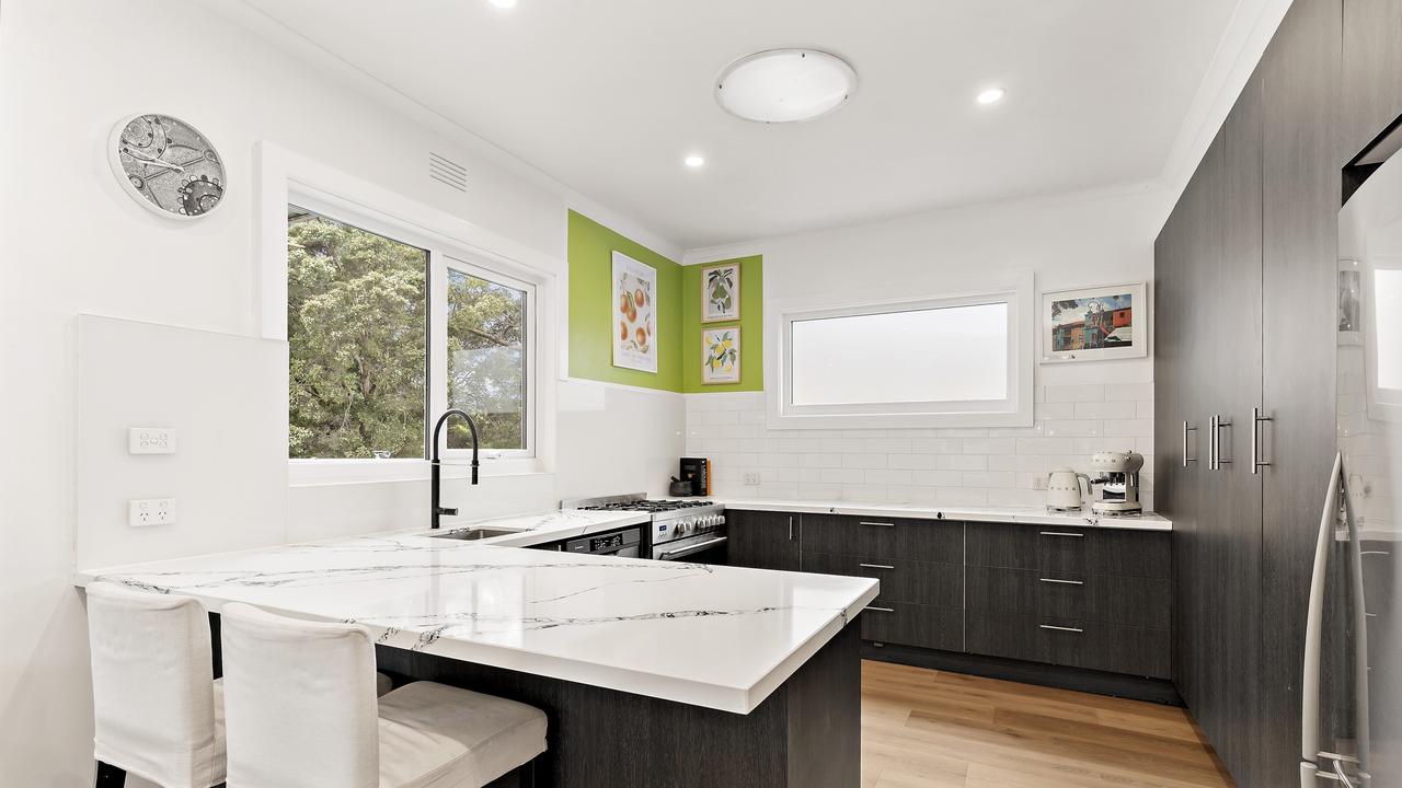 Contemporary kitchen with open-plan design makes entertaining easy for prospective buyers.