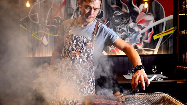 Chef Stanley Wong behind the charcoal grill at the newly opened Eastside Grill restaurant in Chippendale. Photo: Jeremy Piper