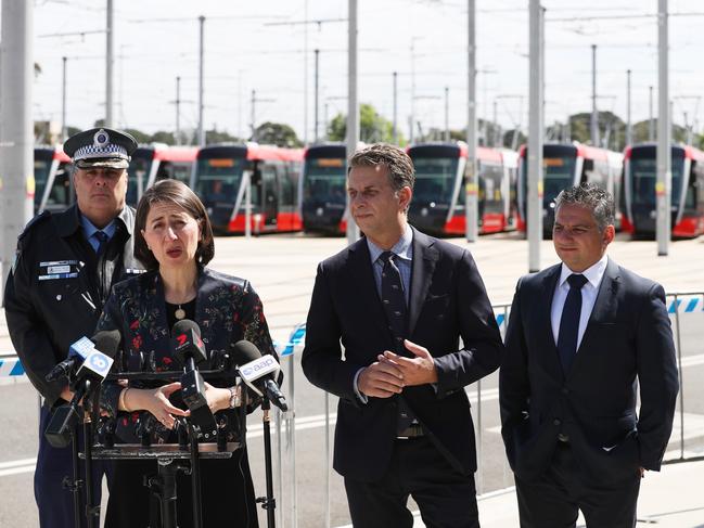 Premier Gladys Berejiklian, Minister for Transport and Roads Andrew Constance, NSW Police Assistant Commissioner Michael Corboy and NRMA Spokesperson Peter Khoury inside the light rail holding yards in Kensington. Picture: John Grainger