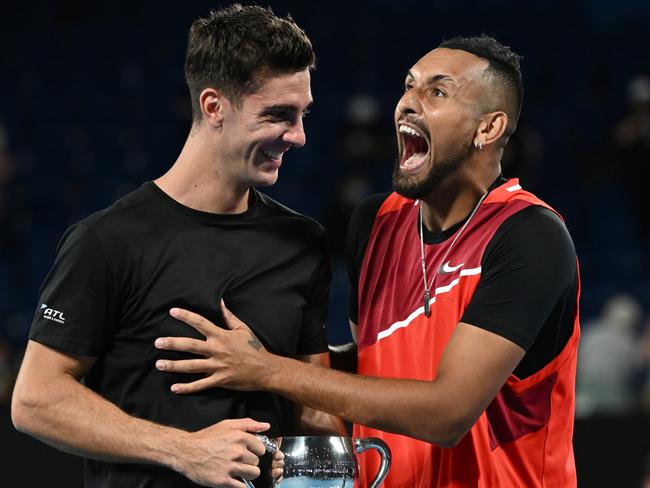 MELBOURNE, AUSTRALIA - JANUARY 29: Thanasi Kokkinakis (L) of Australia and Nick Kyrgios of Australia react after winning their Men's DoublesÃÂ Final match against Matthew Ebden of Australia and Max Purcell of Australia during day 13 of the 2022 Australian Open at Melbourne Park on January 29, 2022 in Melbourne, Australia. (Photo by Quinn Rooney/Getty Images)