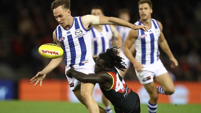 Ryan Clarke of the Kangaroos is tackled by Anthony McDonald-Tipungwuti.