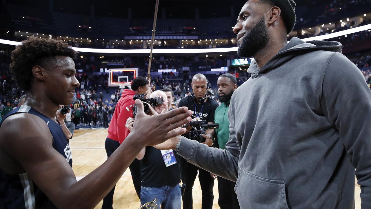 LeBron 'Bronny' James Jr of Sierra Canyon High School daps up his father following a game the younger James played in. Picture: Joe Robbins / Getty Images / AFP