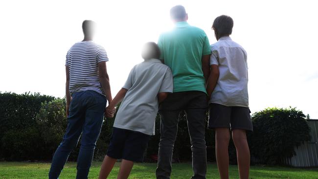 The foster carers with the Indigenous children they have raised since they were babies. Under Australian law they cannot be identified. Picture: John Feder