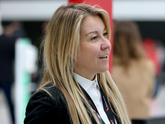 SYDNEY, AUSTRALIA - NewsWire Photos JULY 1, 2022: Qantas executive Olivia Wirth pictured helping people check in at T3 Qantas Domestic departures terminal at Sydney Airport ahead of the Winter School Holidays.Picture: NCA NewsWire / Damian Shaw