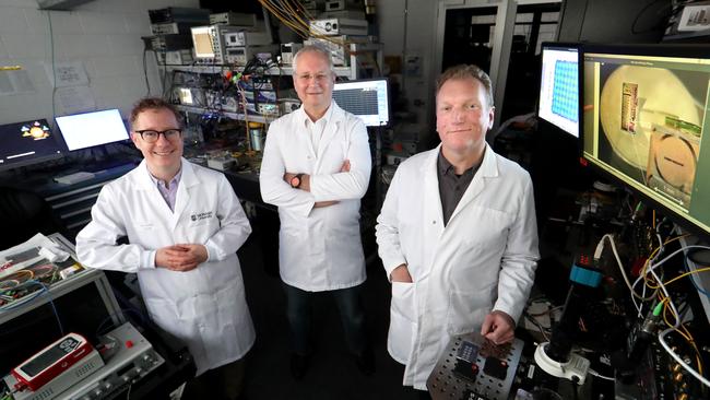 Bill Corcoran, David Moss and Arnon Mitchell in the lab at RMIT. Picture: David Geraghty